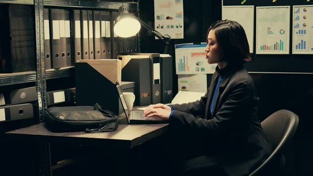 Detective uses forensic techniques to examine evidence stored in the archive, browsing through old classified documents to uncover clues. Private inspector studying classified information. Camera B.