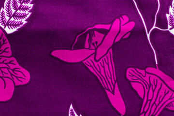 Fototapeta premium top view of pink ankara fabric, flatlay of nigerian wax cloth with designs, spread out pink ankara material