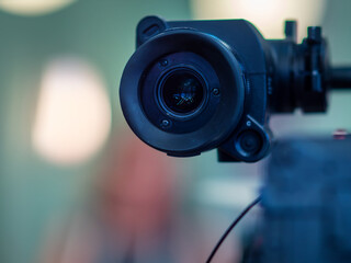 Fototapeta na wymiar Close-up of Professional Video Camera Lens in Studio