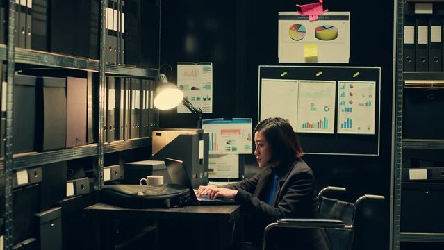 Wheelchair user and inspector analyzing criminal records in police archive room, cross reference data from cases to identify similarities. Team of agents compile notes on crime trends. Camera A.