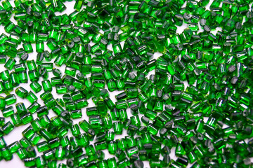 Transparent green masterbatch granules on a white background, this polymer is a colorant for...