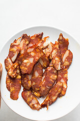 Top view of thinly sliced chinese sausage, overhead view of sliced lap cheong sausage on white background