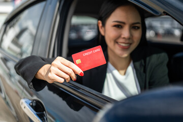Young beautiful asian business women getting new car. Hand holding credit card payment. Car owner...