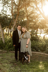 Young Christian Family Formal Church Dressed Smiling Happy With Dog