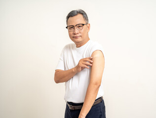 Fototapeta premium Senior man shows plastered shoulder arm after getting flu influenza vaccine. Mature Old people vaccination immunization. Health care medical.