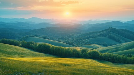 mountainous countryside at sunset. landscape with grassy rural fields and trees on hills rolling in to the distance in evening light.
