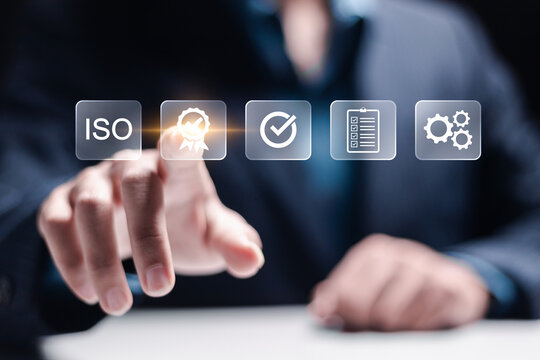 ISO Certification and standardization process concept. Certificate, Approval, Compliance to requirements. Businessman touching quality assurance icon for international standards.