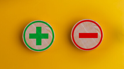 Wooden block Shows plus and minus symbols. The concept of opposites, decisions, and uncertainty....