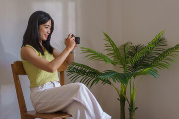 Needlework concept, Women smile and use camera to taking photo handicraft in embroidery workshop