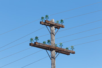 Wires and glass insulators on an old pillar