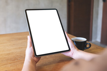 Mockup image of a woman holding digital tablet with blank white desktop screen