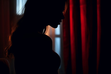 a woman in a room at night. the profile of a single woman in silhouette, with parted lips. the concept of sexuality, sadness, time for yourself