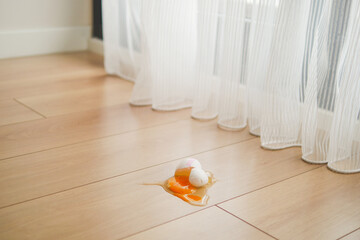 Fresh broken egg in kitchen floor