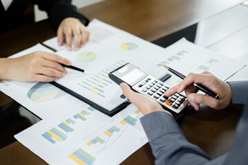 Business leaders talk about charts and financial graphs showing results are analyzing and calculating planning strategies, business success-building processes