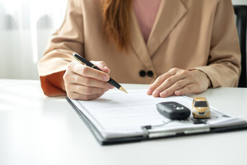 Fototapeta premium Car dealer businessman signing car insurance document or lease paper. Car loan and insurance concept