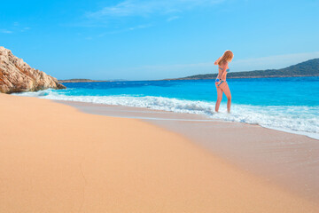 Blonde Girl on tropical beach - Beautiful woman in bikini enjoy a swim in the crystal clear water - Kaputas, Antalya
