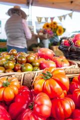 Colorful assortment of fresh organic heirloom tomatoes sitting on wooden table. High quality photo