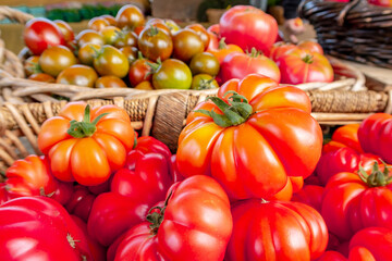 Colorful assortment of fresh organic heirloom tomatoes sitting on wooden table. High quality photo