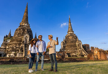 Thai local tour guide is explaining the history of old Siam to the couple of tourist on their...