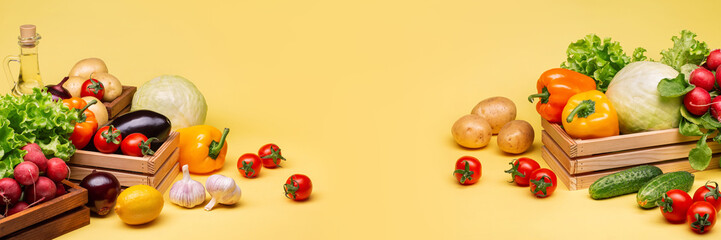 Horizontal banner with vegetables on a yellow background. Tomatoes, onions, eggplant, peppers, radishes, cabbage, cucumber, lettuce and garlic. Photo.