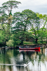 Moored boats on river in Killarney National Park, Ireland. High quality photo