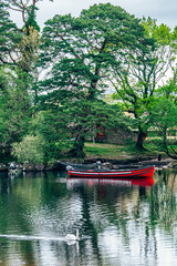 Moored boats on river in Killarney National Park, Ireland. High quality photo