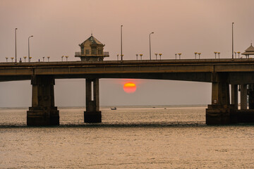 scenery The red sun down to the behind Sarasin bridge Phuket..Scene of Colorful romantic red sunset with the bridge in sunset background..Bridge connecting the outside world to Phuket Island.