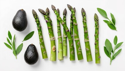 Green herbs, asparagus and black avocado on a white background