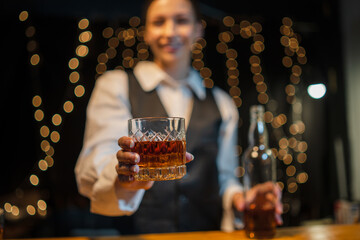 Barwoman pouring whiskey whiskey glass..