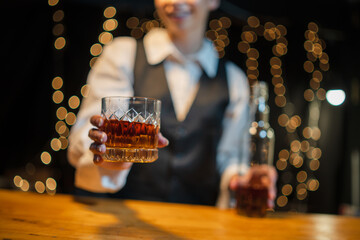 Barwoman pouring whiskey whiskey glass..