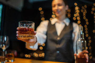 Barwoman pouring whiskey whiskey glass..