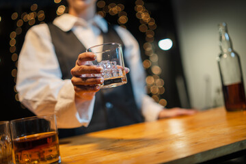 Barwoman pouring whiskey whiskey glass..