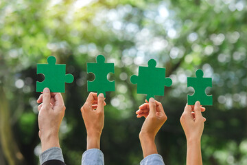 World environment day and ESG Concept of teamwork and partnership Hands join Jigsaw puzzle pieces with global community sustainable Save Earth. the Environment World Earth Day concept - Powered by Adobe