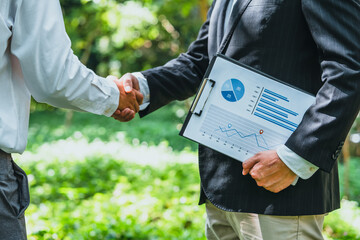 .World Environment Day business partner colleagues shaking hands during a meeting working together...