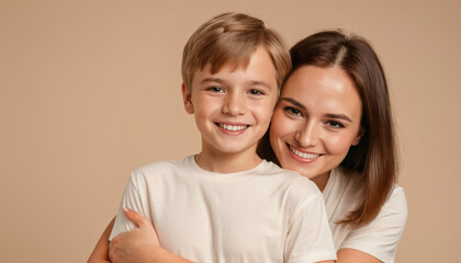 happy woman hug her son on beige background with copy space. Concept of Mothers day