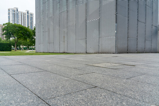 empty concrete floor in front of modern buildings in the downtown street. copy space for parking lot.