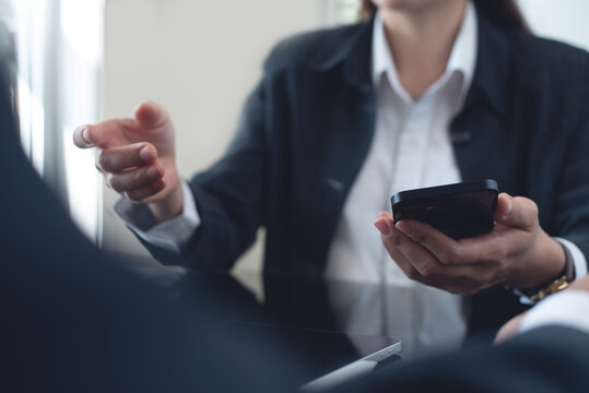 Co-working team brainstorming in modern office. Two asian business colleagues have a discussion, planning work project and researching process. Business teamwork, corporate business
