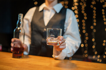 Barwoman pouring whiskey whiskey glass..
