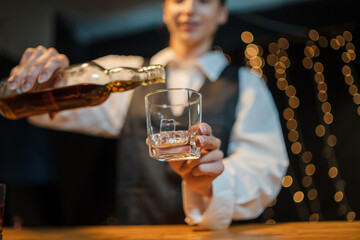 Barwoman pouring whiskey whiskey glass..