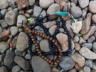 Top view of two prayer beads on the pebbles. 