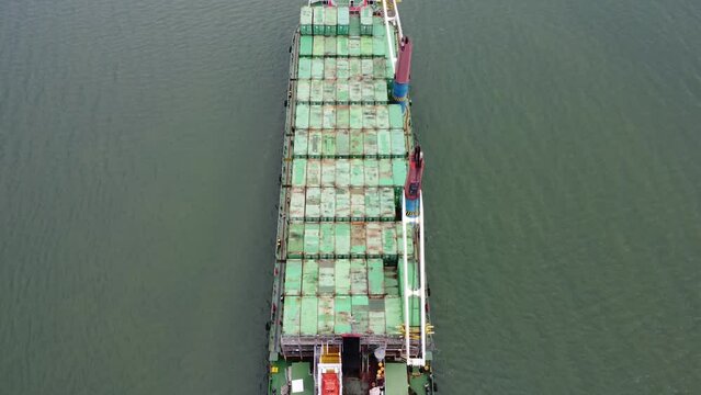 Aerial view of a large ship carrying containers in the Kalimantan sea, delivering containers