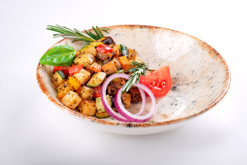 Vegetable Ratatouille with tomatoes, zucchini, pepper and seasonings in a plate on a white background. A traditional French vegetable dish cooked in the oven