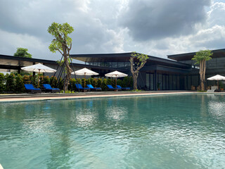 Swimming pool at a club house in Indonesia. Lovely swimming pool with cloudy blue sky.