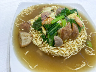 Ifumi is an Indonesian crispy deep fried thick noodle dish, popular in Indonesia, served in a thick savoury sauce with pieces of meat or seafood and vegetables.