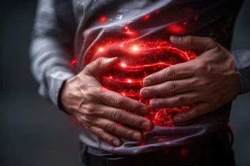 Fotobehang Stomach ulcer, man with abdominal pain suffering on a gray background, symptoms of gastritis, diseases of the digestive system, health problems concept © staras