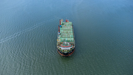 Aerial view of a large ship carrying containers in the Kalimantan sea, shipping containers, inter...