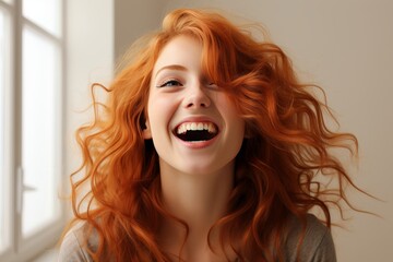 Joyful young woman smiling with wide open mouth in professional studio against seamless backdrop
