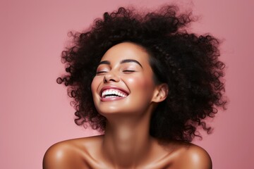 Portrait of beautiful afro woman smiling with flawless, glowing skin and radiating confidence