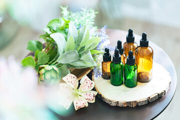 Oil bottle and green herbs. Essential oil. Aromatherapy.