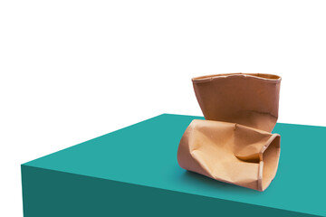 Brown crumpled paper cups setting on dark green mockup isolated on white background.